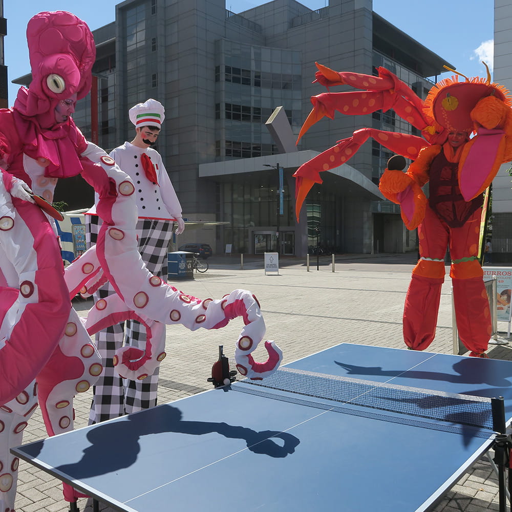 Performers playing table tennis