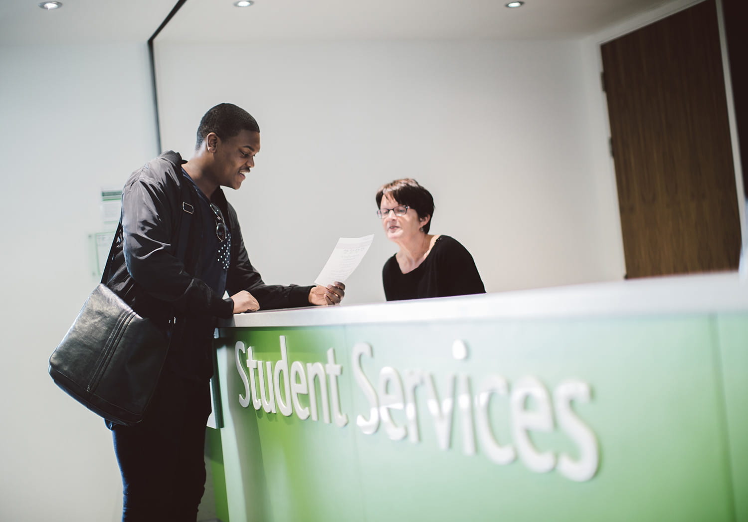 Student enquiring at student services desk