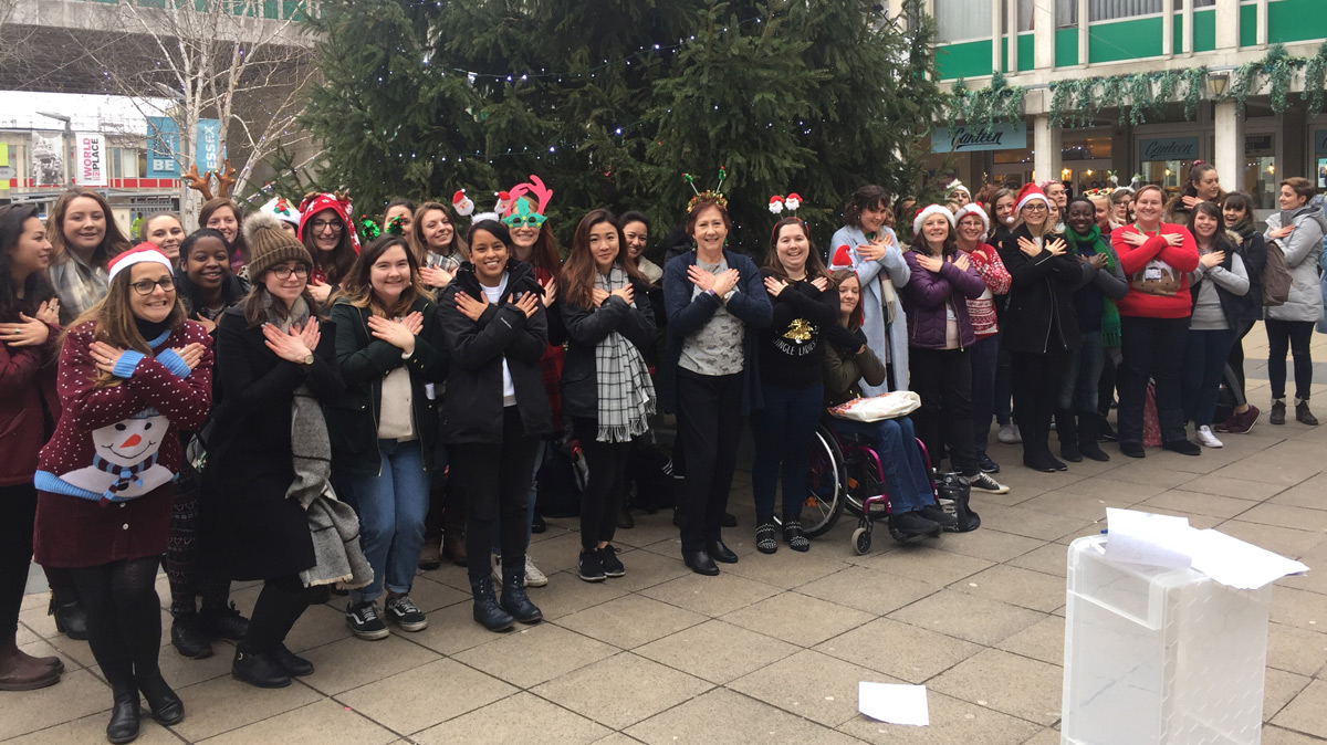 MSc Speech and Language Therapy students and lecturer Sally Austin sing and sign Christmas carols)
