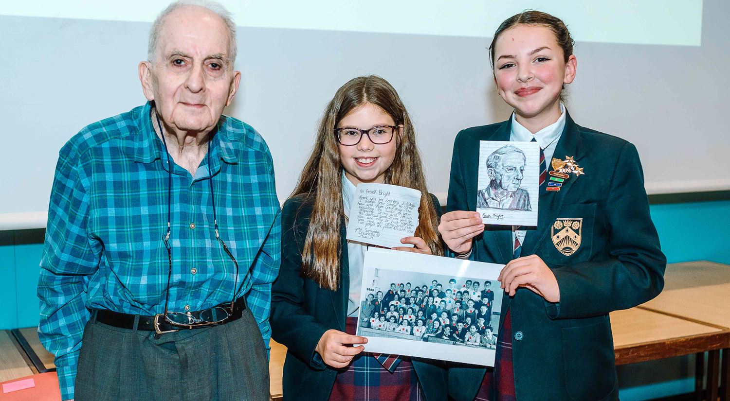 Frank Bright MBE with Ormiston Denes Academy pupils presenting him with work inspired by his talk at the 2020 Dora Love Prize
