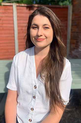 Grace Watson, wearing a white, short-sleeved shirt 
