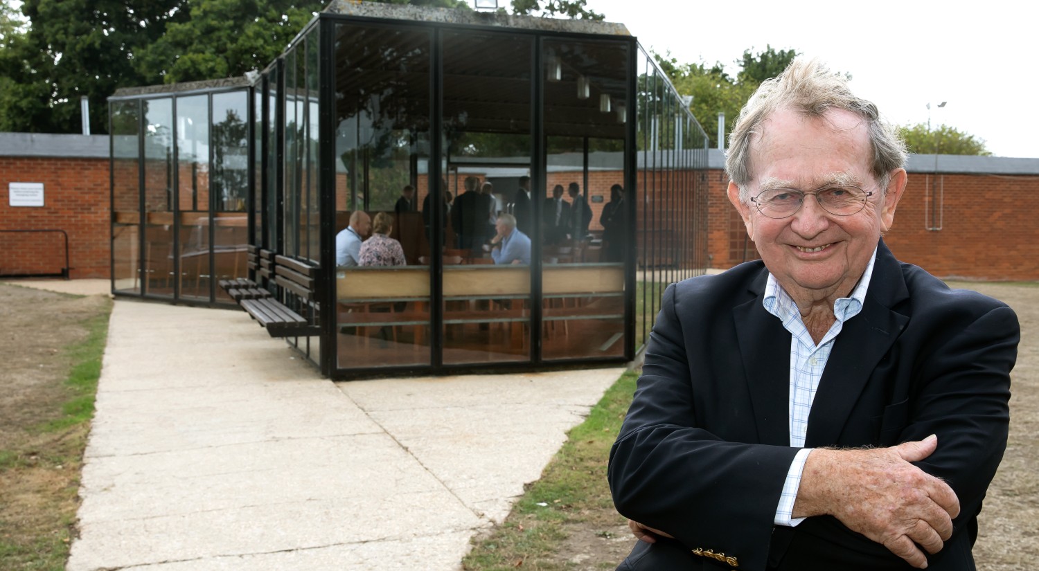 John Meunier in front of the Sports Pavilion he designed