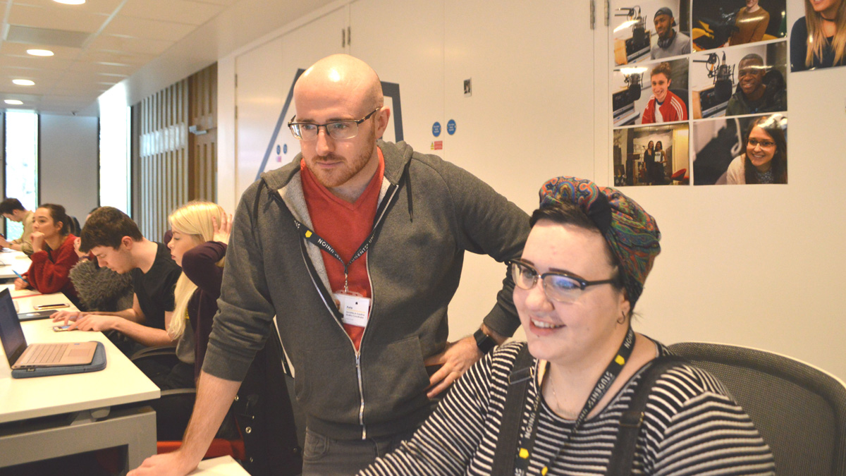 Peter Coxell overseeing a student's work on the Rebel website)