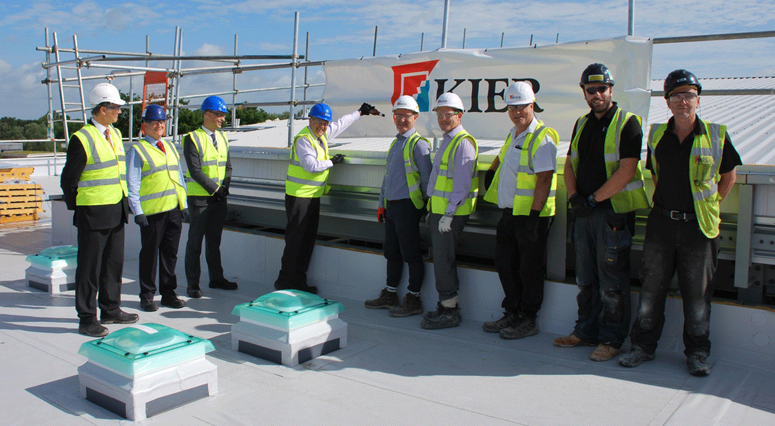 Bryn Morris, Registrar, marks the topping out