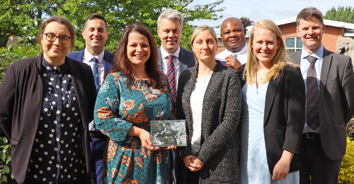 The Outreach team and school representatives with the award)