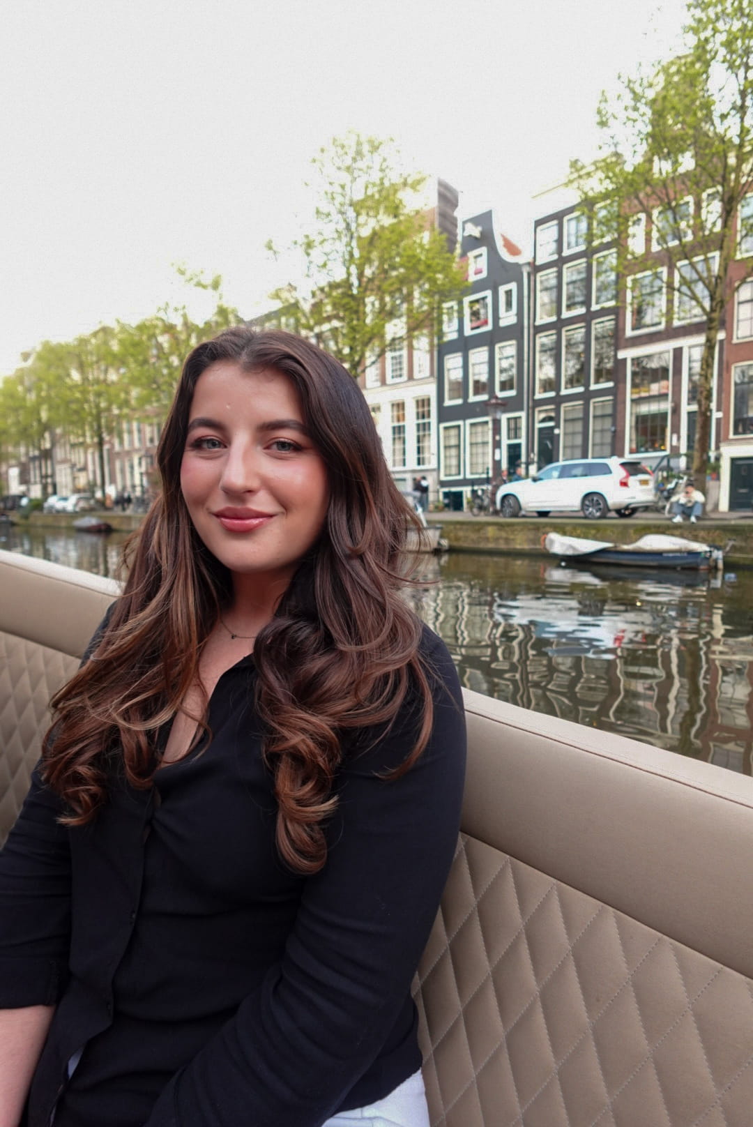 Kristina is stood by a canal in Amsterdam