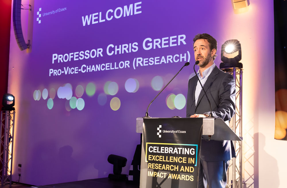 Research Impact awards 2022 Chris Greer speaking at the podium 