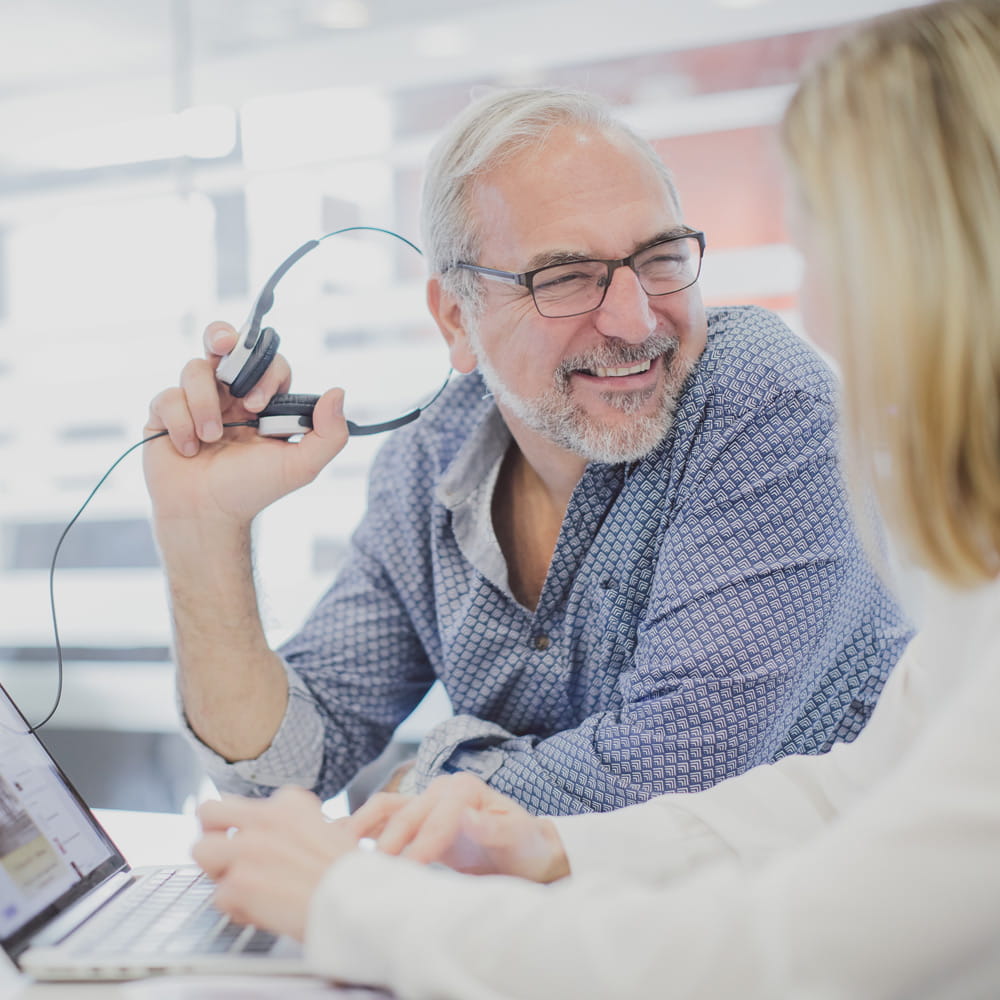 Two researchers talking over a laptop