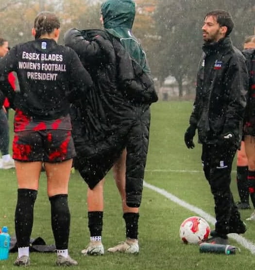 Womens Performance Football Coach Oliver Gulliver with Essex Blades women's team players outside in the rain training