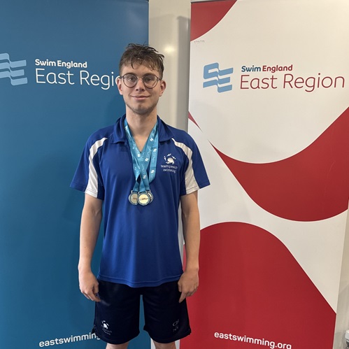 University of Essex performance sport scholar Corey Hare wearing medals around his neck following a successful para swimming event competing at Swim England East Region