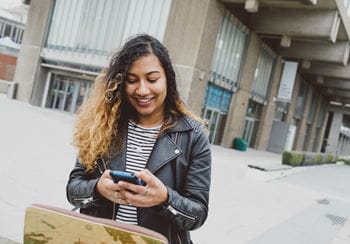 Girl on her phone outside the library