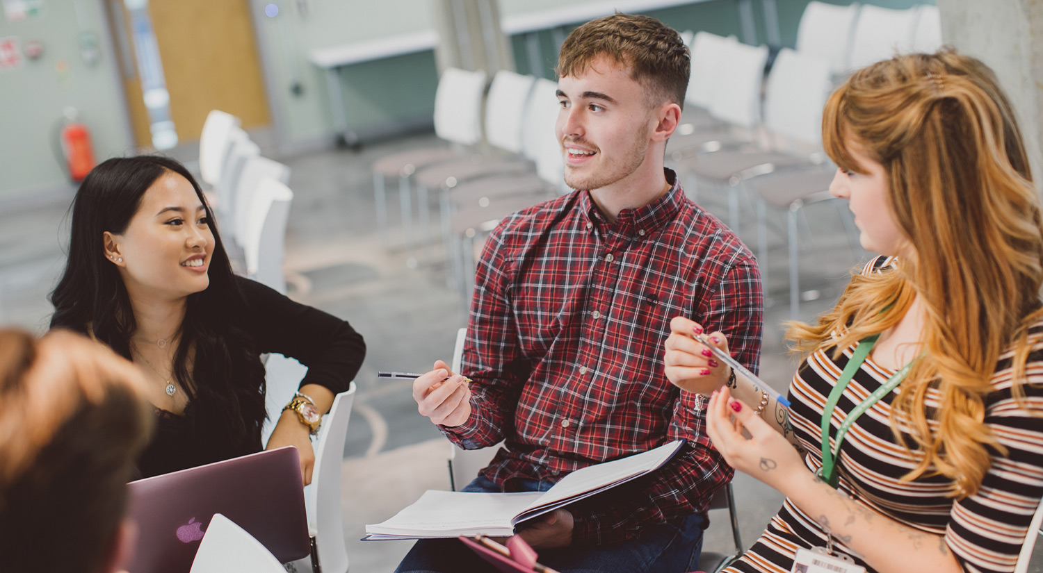 Students chatting and working together in a communal learning space