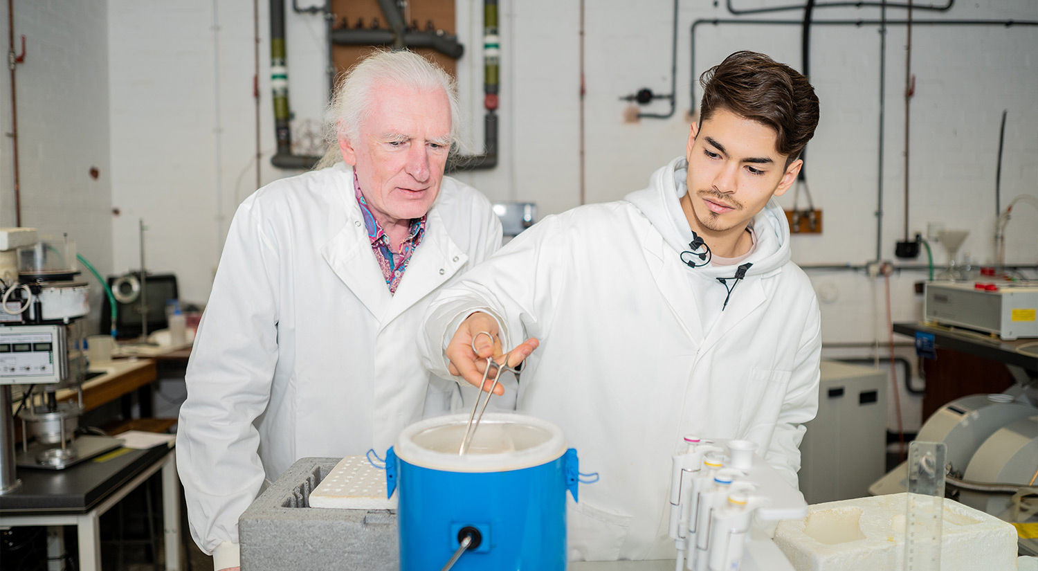 A student and a member of staff use liquid nitrogen in a lab