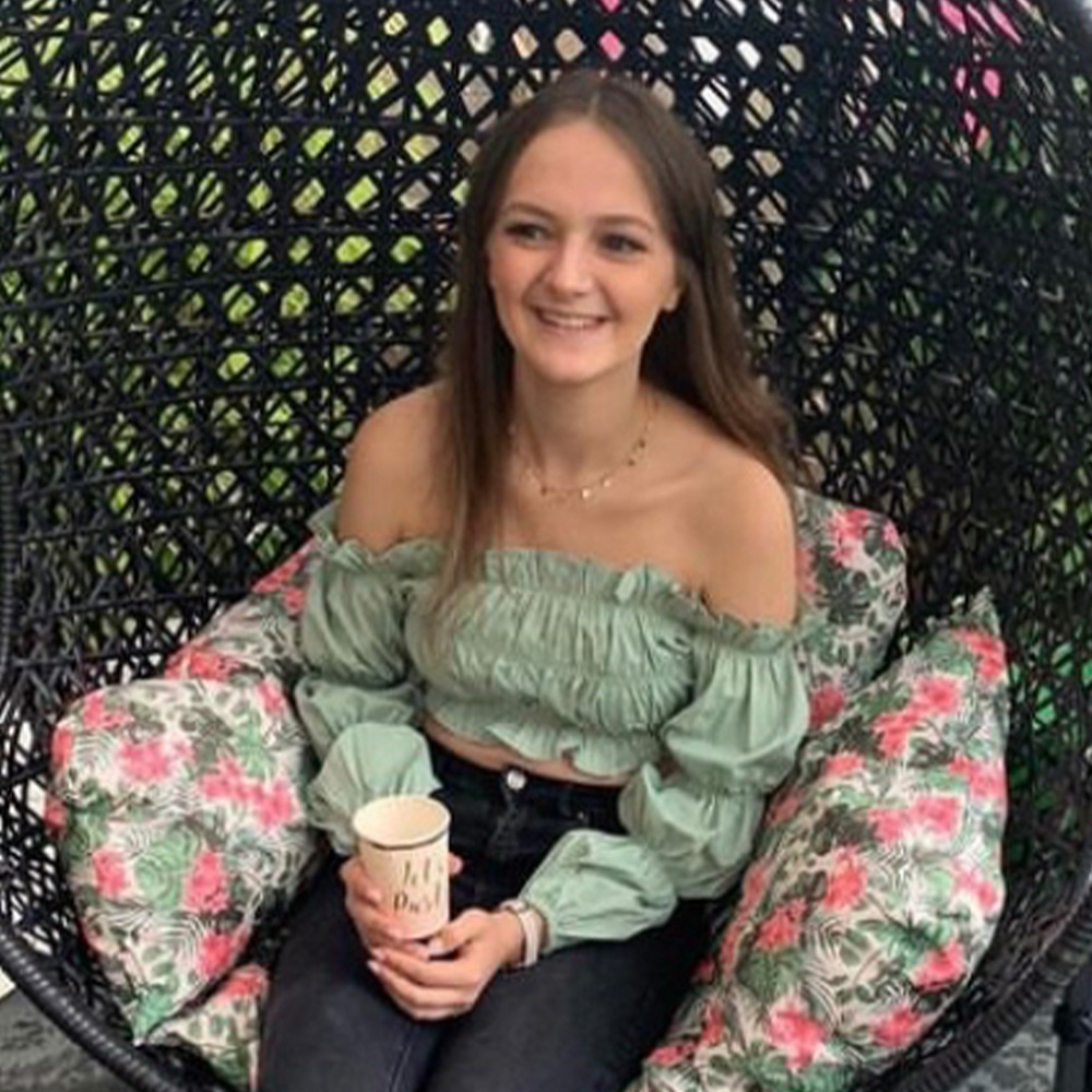 Photo of Phoebe Taylor sitting down smiling
