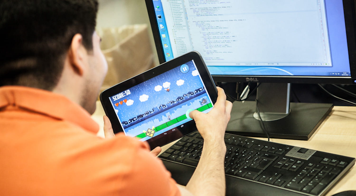 Image of a student developing a mobile game for a tablet