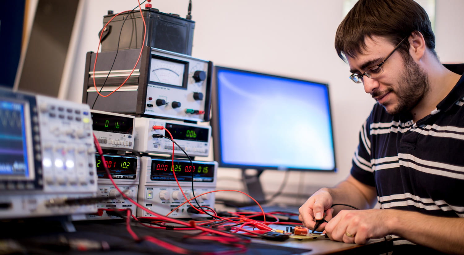 A student in an electronic labs working with equipment