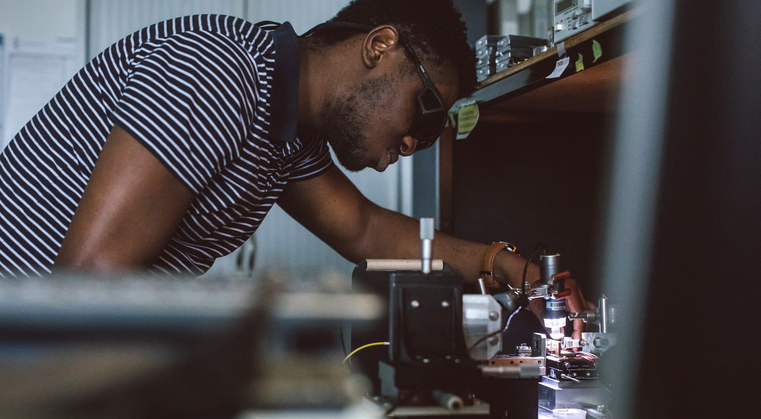 A student using optoelectronic equipment