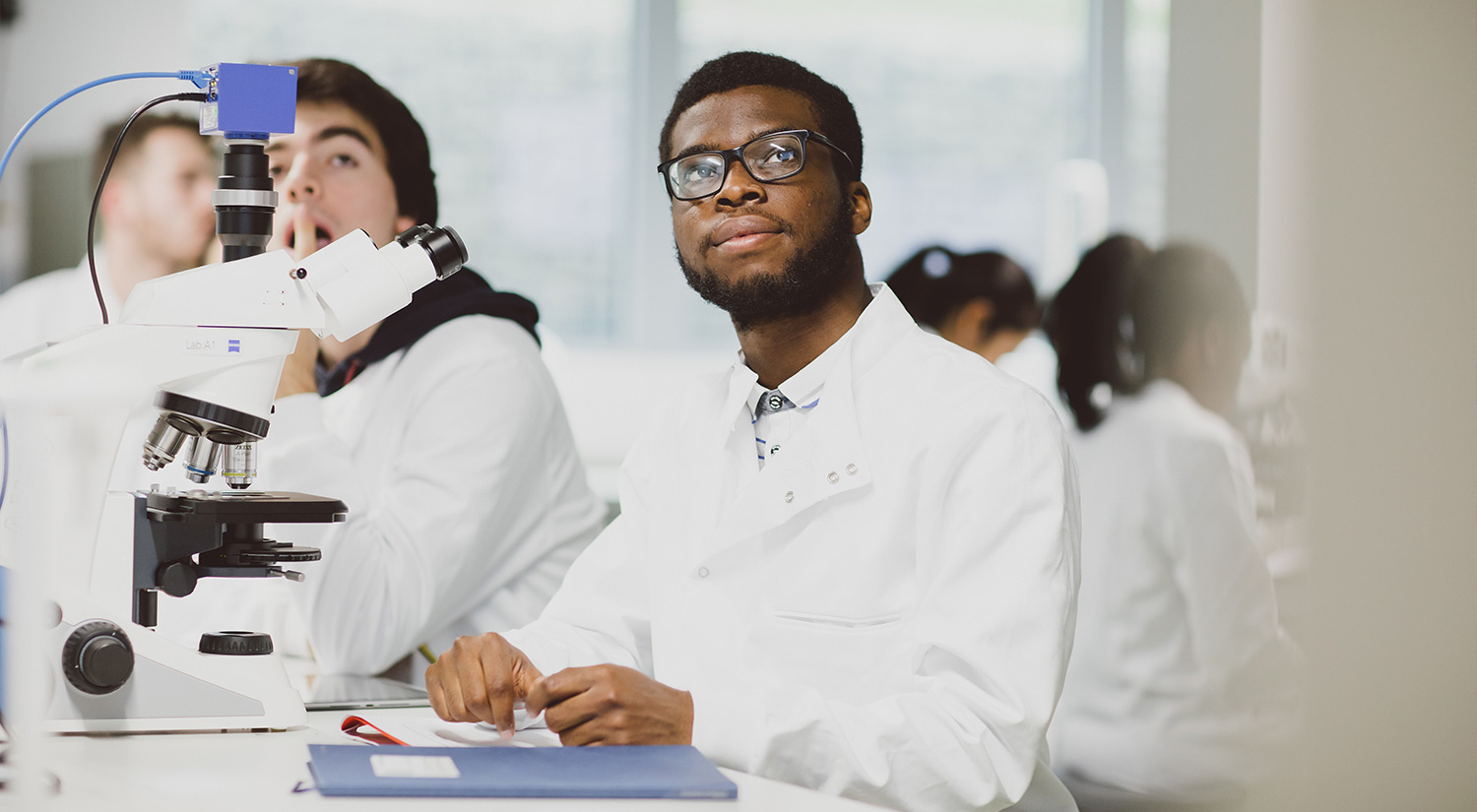 A student in a lab listening to a lecture