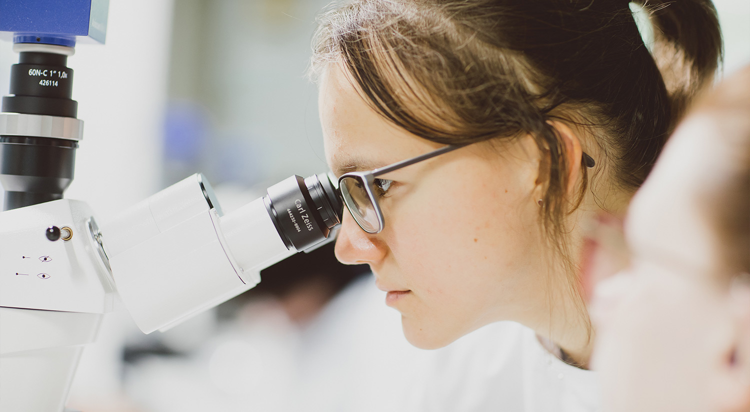A student looking through a microscope