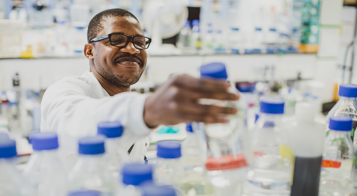 A research student using equipment in a biology lab