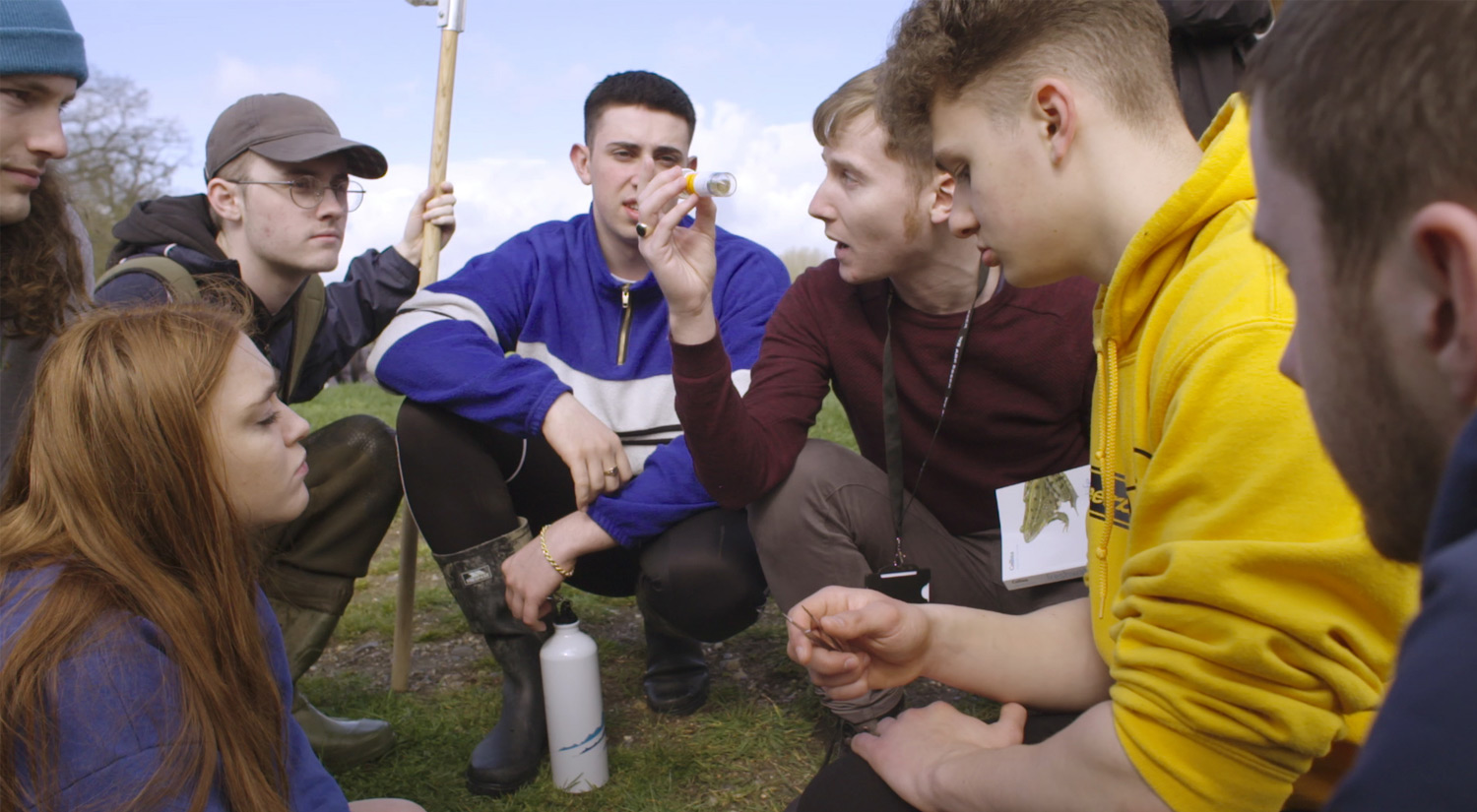 A group of marine biology students working together in the field in the local village of Dedham taking samples.