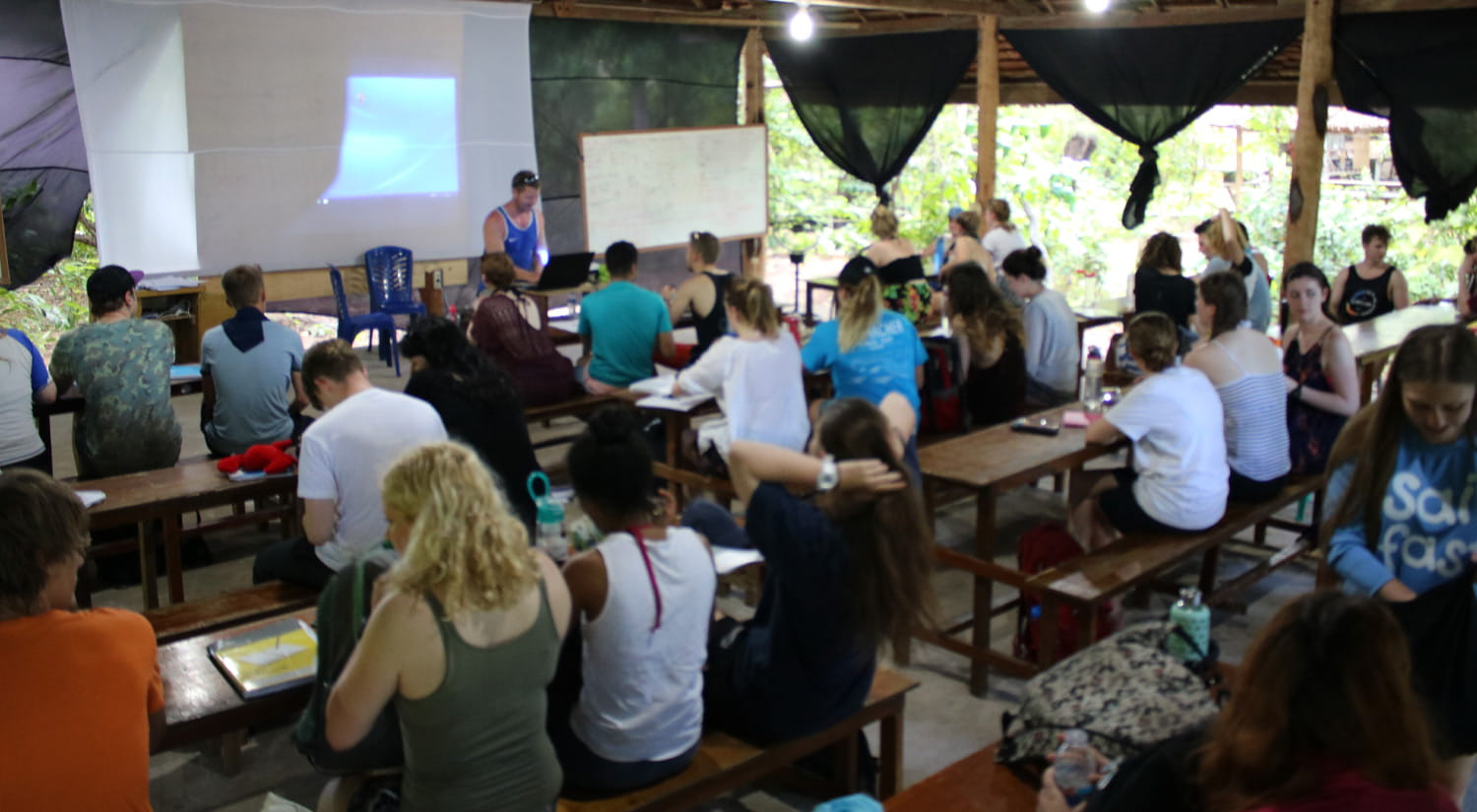 Students attending a seminar on Hoga Island, during the Indonesia marine biology field trip.