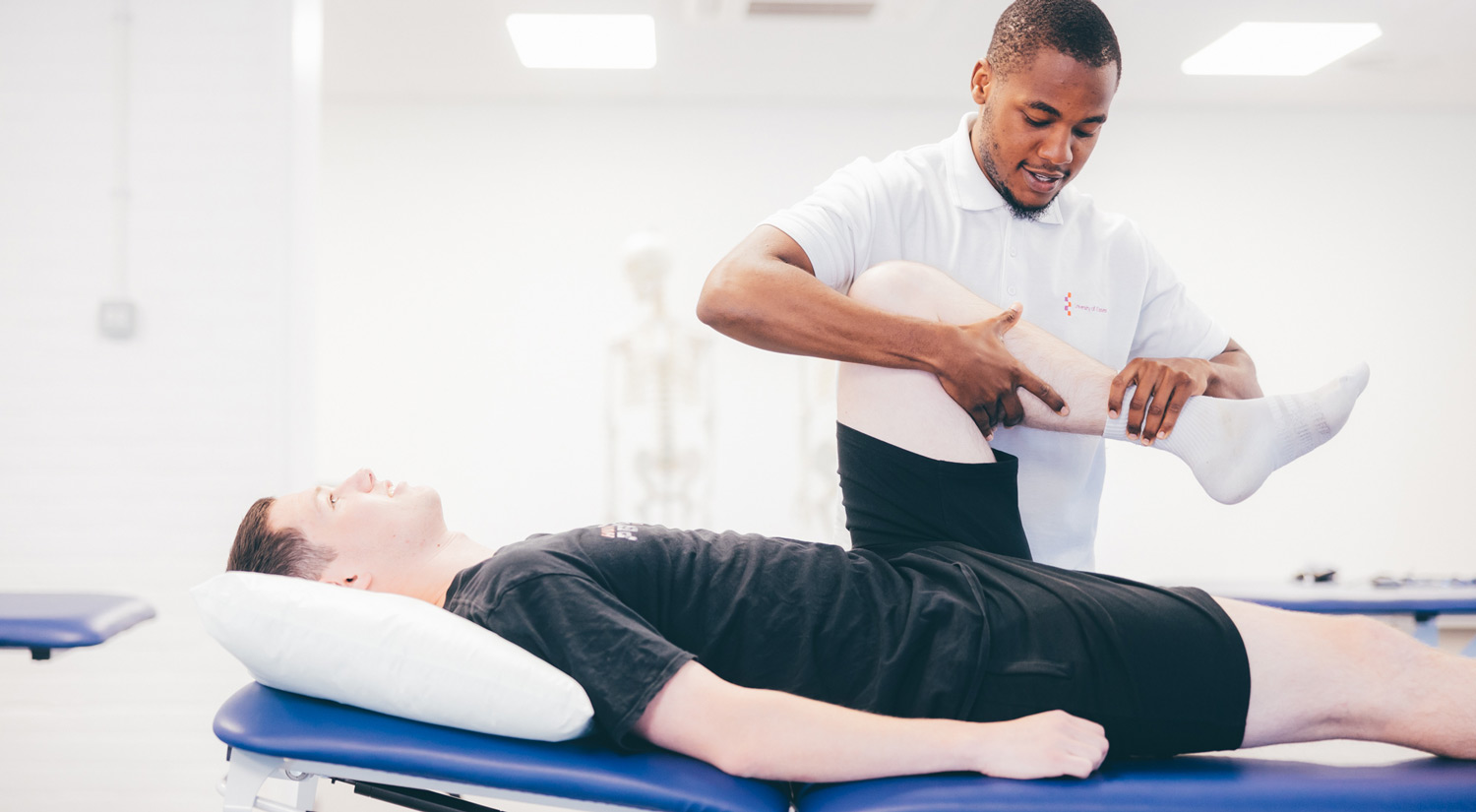 Physiotherapy student practicising techniques with another student