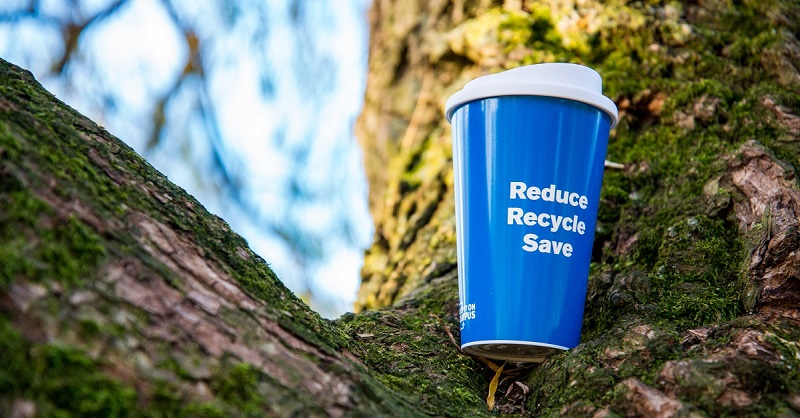 Blue reusable coffee cup with Reduce Recycle Save written on it