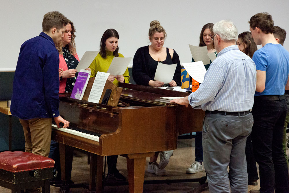 University of Essex Choir rehearsing around the piano
