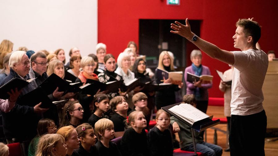 Ben Vonberg-Clark conducting both the adult and children's choir