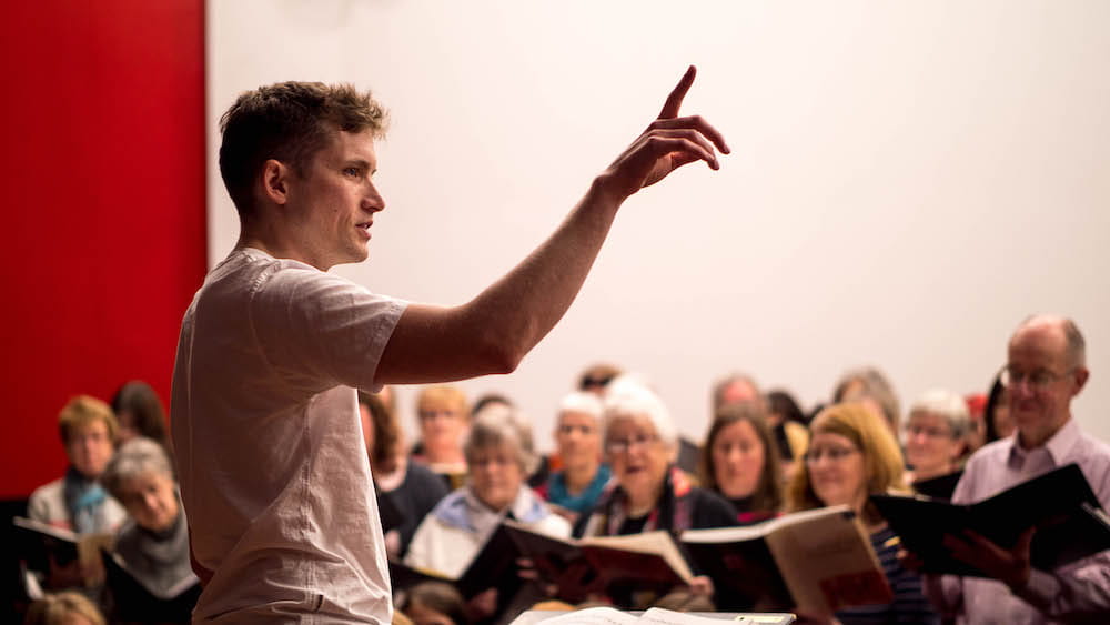 Ben Vonberg-Clark conducting the choir