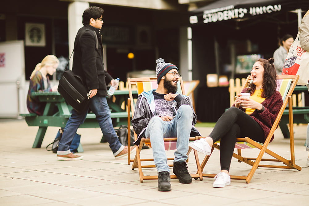 Students sitting in deckchairs on the Squares