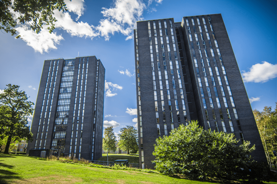 Two tower blocks with a blue sky background
