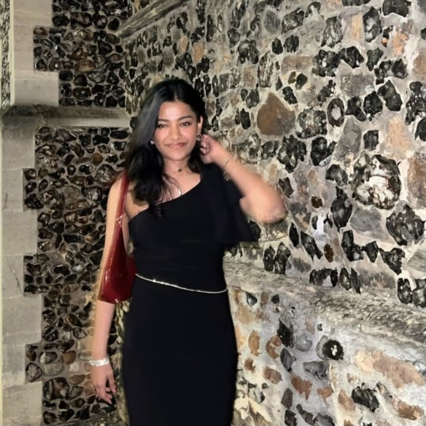 Student in front of a brick wall, dressed up for the Law Ball