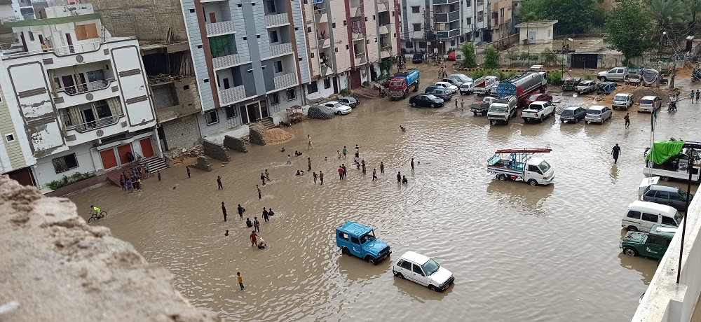 Image showing urban area flooded with cars and people in the water