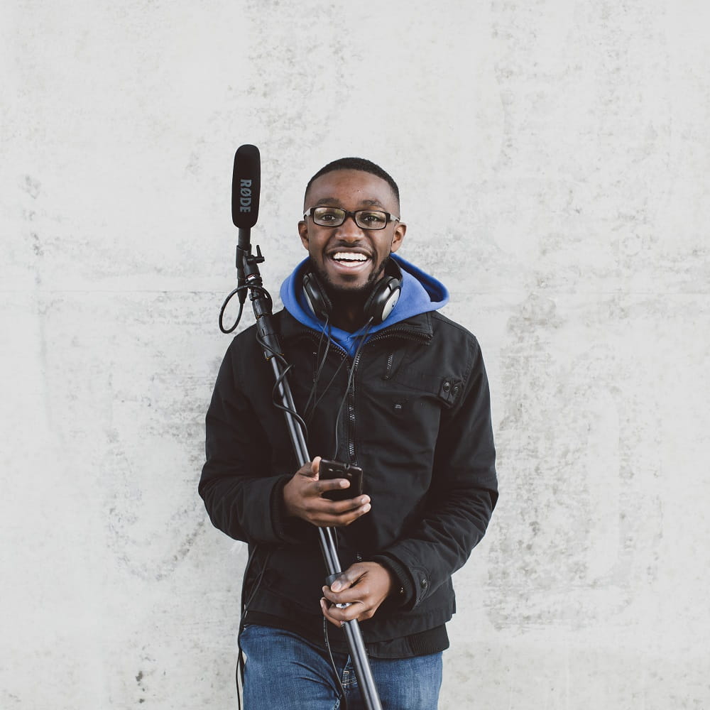 Media student holding a microphone